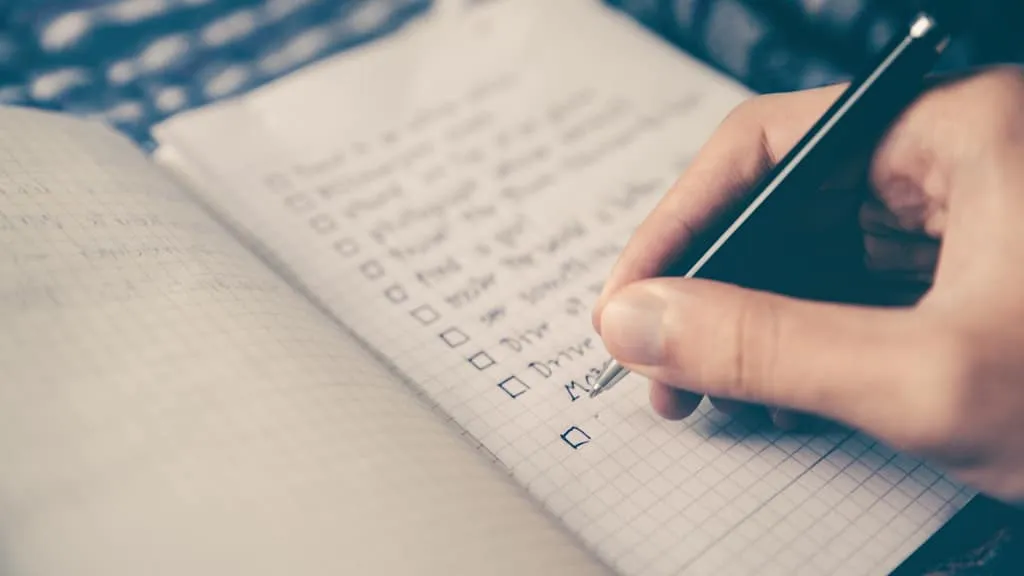 A person checking a list of items for their insurance claim on their roof replacement